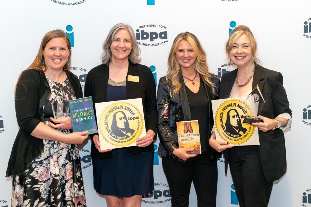 PHOTO CAPTION: Author Amanda Huffman (A Girl's Guide to Military Service), Publisher Karen Pavlicin (Elva Resa Publishing), Publisher JuLee Brand (W. Brand Publishing), and Author Julie Tully (Dispatches from a Cowgirl) celebrate together the publishers receiving GOLD IBPA Benjamin Franklin Awards at a May 5, 2023 ceremony in Coronado Island, California. This award honors excellence in editorial and design by independent publishers. Military-connected books from both publishers are available through Military Family Books distribution.